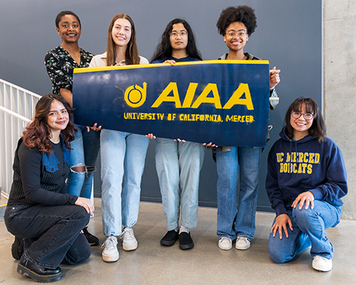 AIAA students with banner