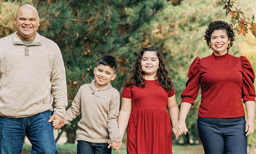 A family of four walking