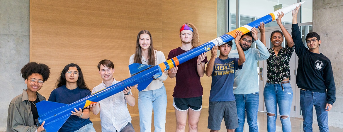 Students holding rocket